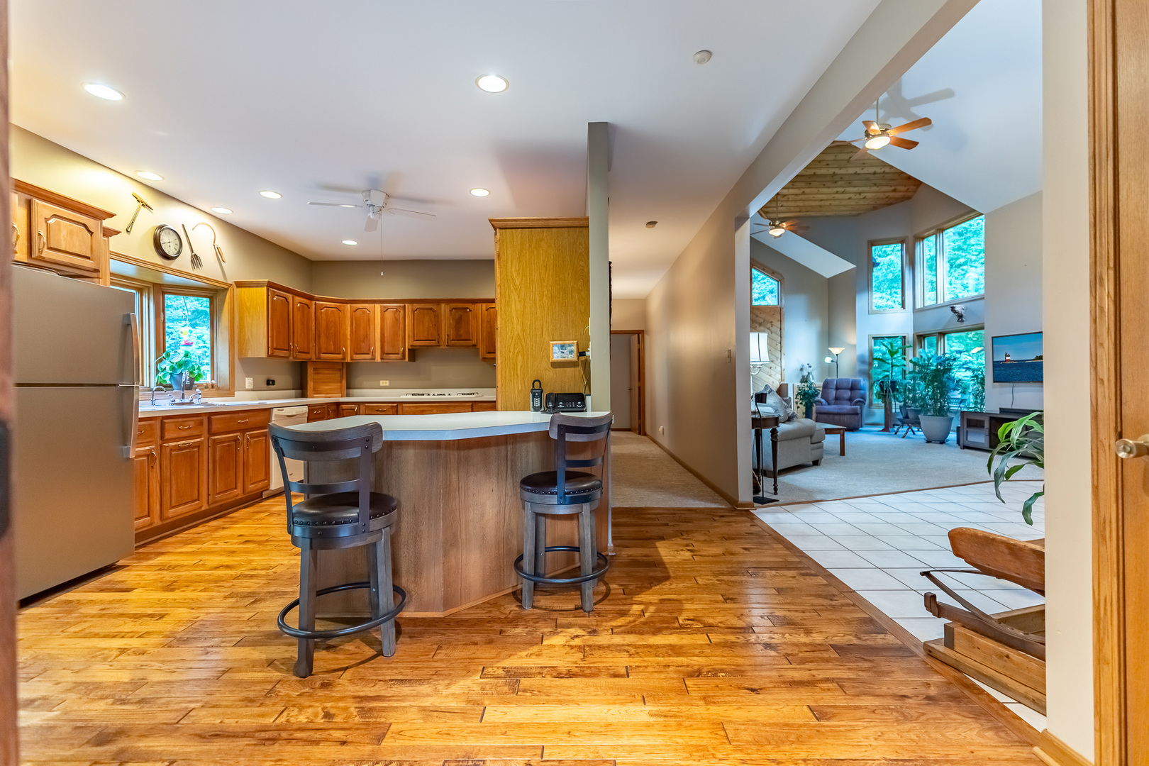 3530 East Challas Entrance Crete, IL 60417 - Photo 17 of 60 a kitchen with stainless steel appliances kitchen island granite countertop dining table chair and a refrigerator