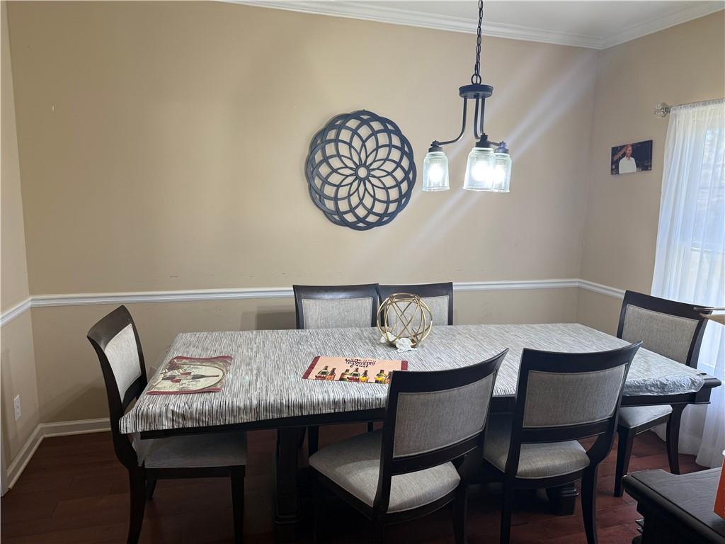 2390 Walnut Grove Way Suwanee, GA 30024 - Photo 11 of 22 a view of a dining room with furniture and a chandelier