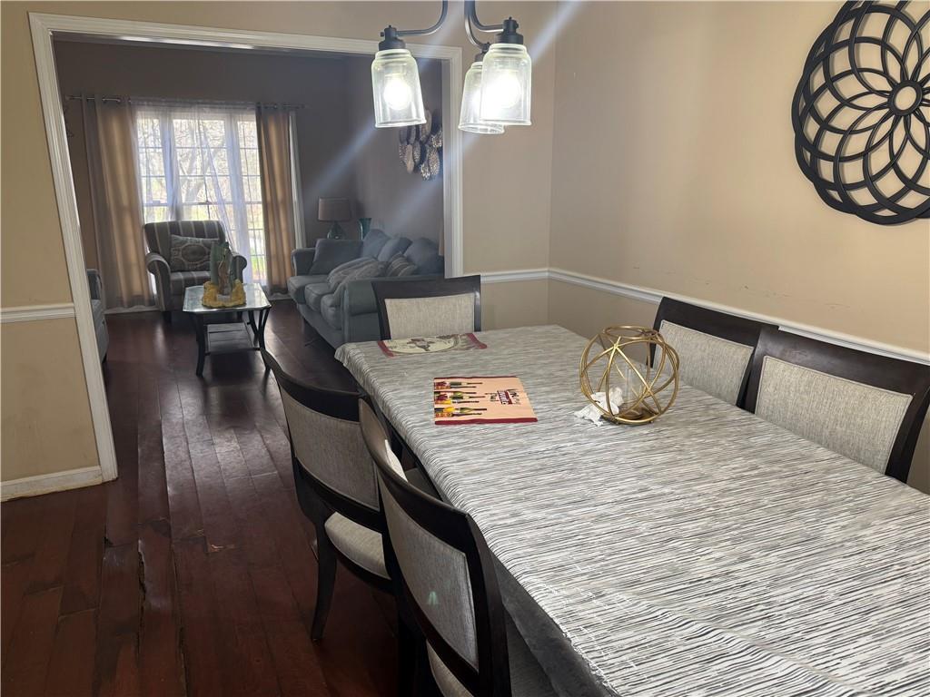 2390 Walnut Grove Way Suwanee, GA 30024 - Photo 12 of 22 a view of a dining room with furniture and wooden floor