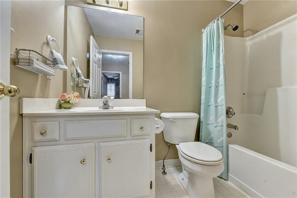 2390 Walnut Grove Way Suwanee, GA 30024 - Photo 17 of 22 a bathroom with a sink vanity mirror and toilet