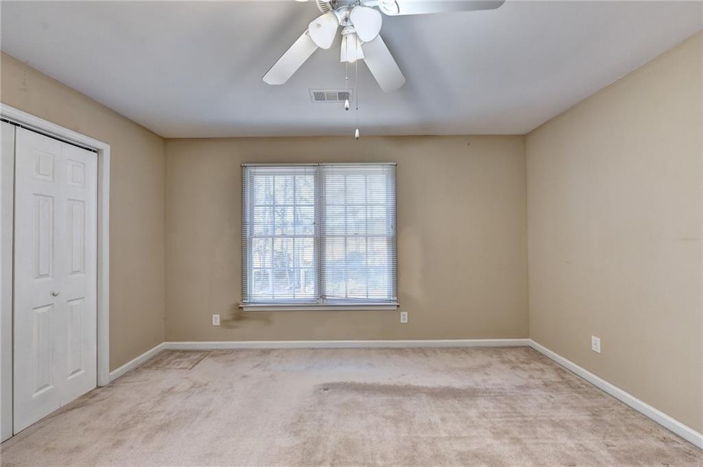2390 Walnut Grove Way Suwanee, GA 30024 - Photo 18 of 22 an empty room with a empty space and windows