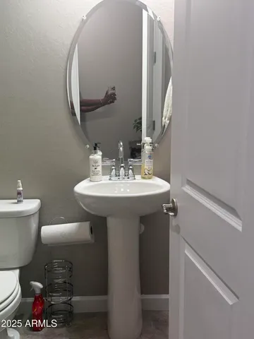 a bathroom with a sink toilet and a mirror