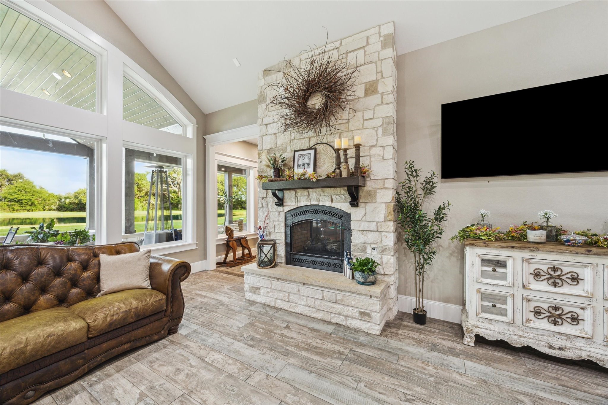 1255 Bronco Trail Angleton, TX 77515 - Photo 12 of 50 a living room with furniture a fireplace and a flat screen tv