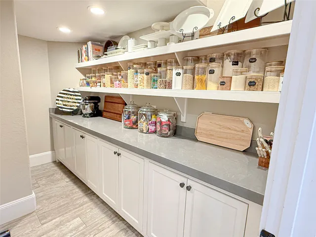 a large kitchen with a table and chairs