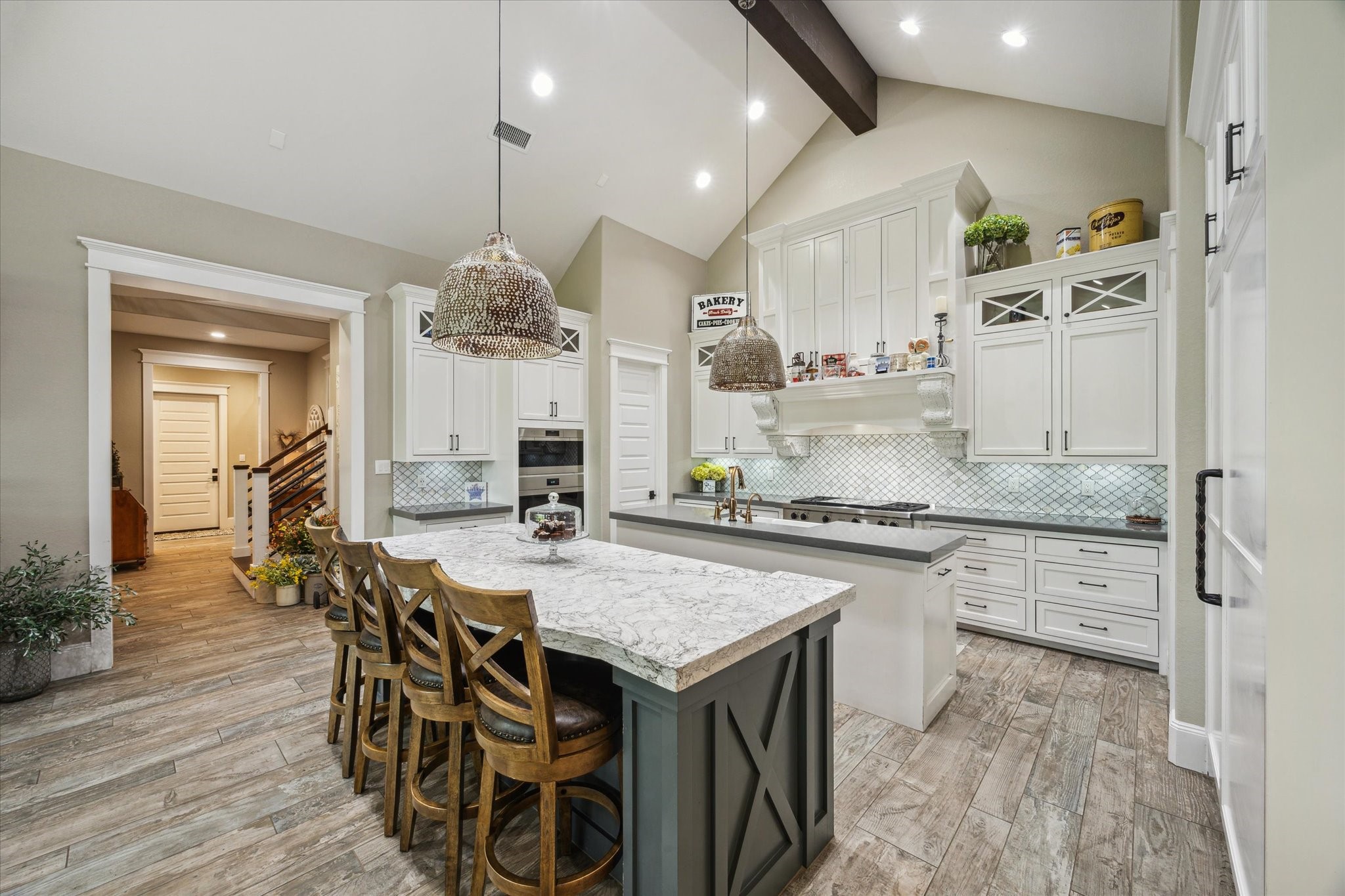 1255 Bronco Trail Angleton, TX 77515 - Photo 7 of 50 a kitchen with stainless steel appliances granite countertop a kitchen island a stove a table and chairs in it