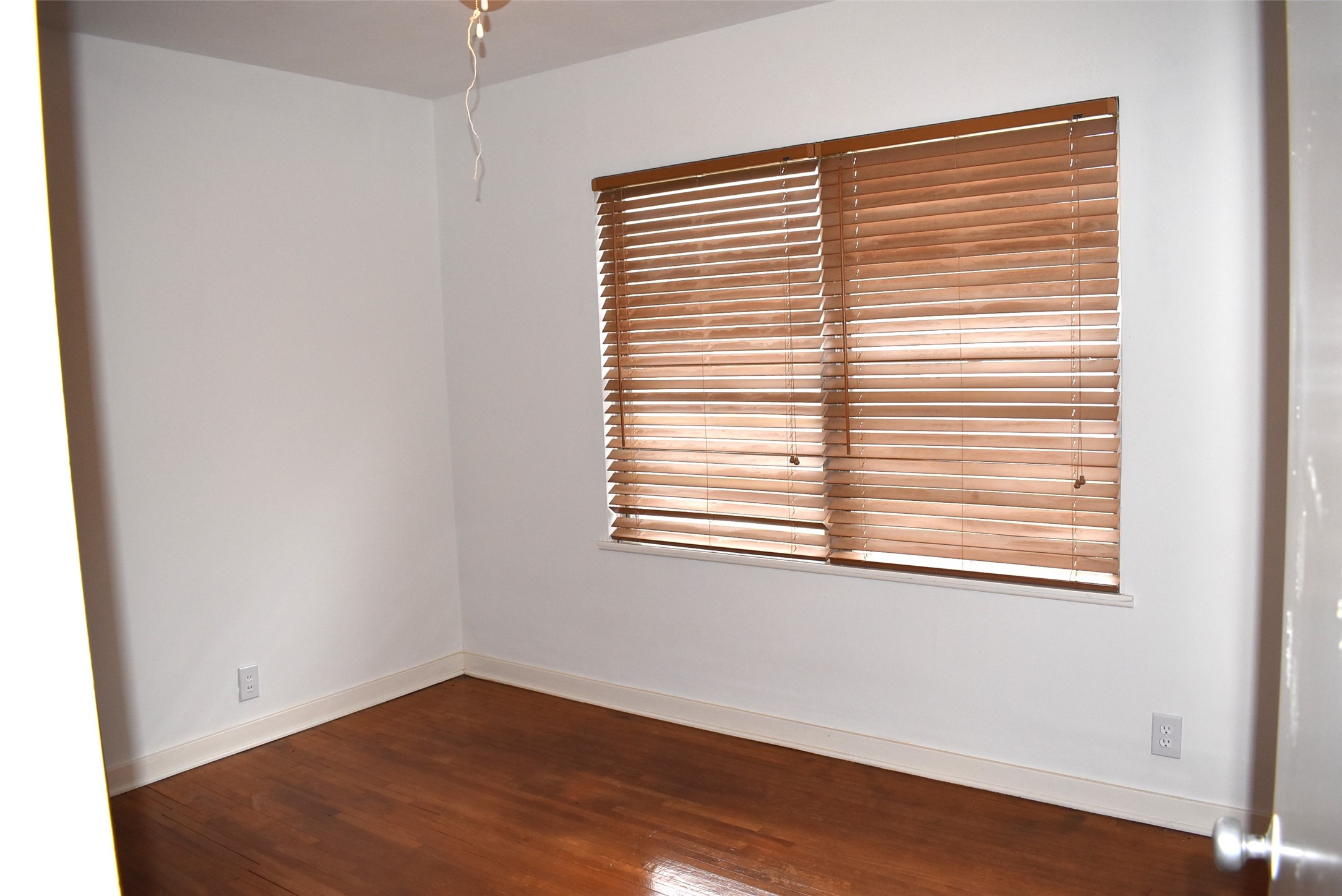 1006 Mac Drive Sweeny, TX 77480 - Photo 24 of 43 a view of an empty room with wooden floor and a window