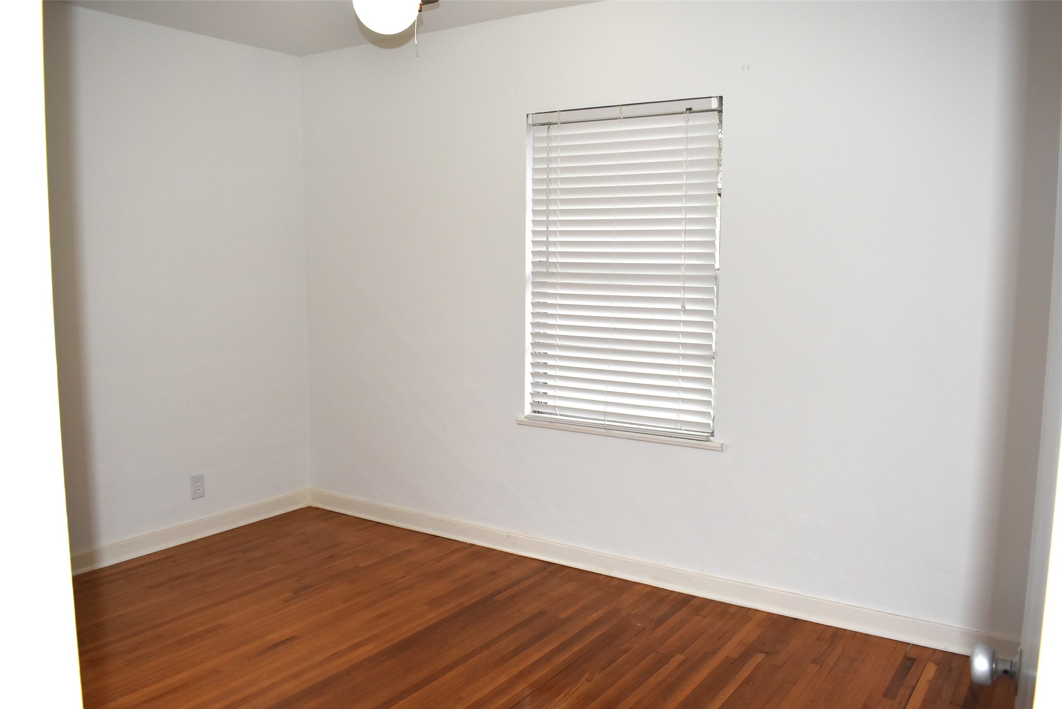 1006 Mac Drive Sweeny, TX 77480 - Photo 26 of 43 an empty room with wooden floor and windows