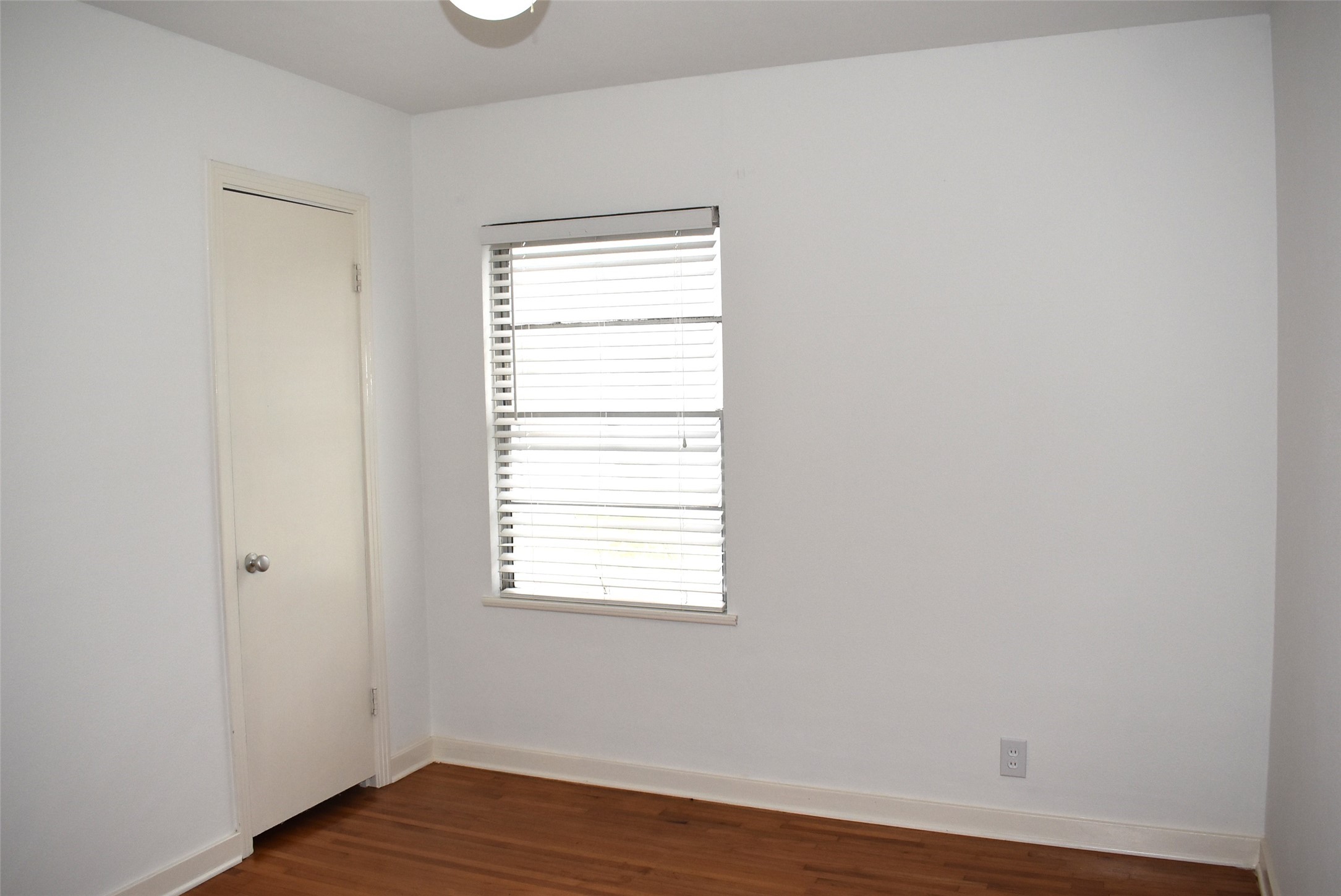 1006 Mac Drive Sweeny, TX 77480 - Photo 27 of 43 an empty room with wooden floor and a window