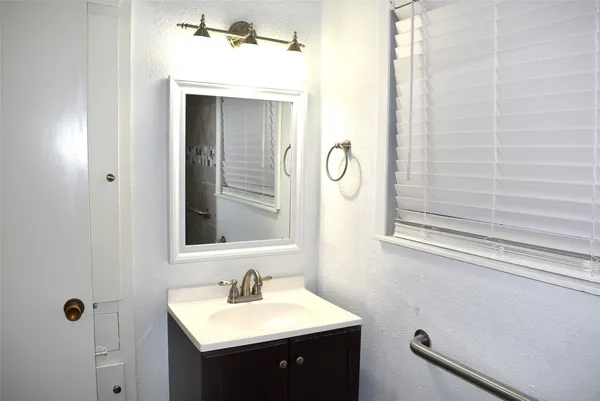 a bathroom with a sink and a mirror