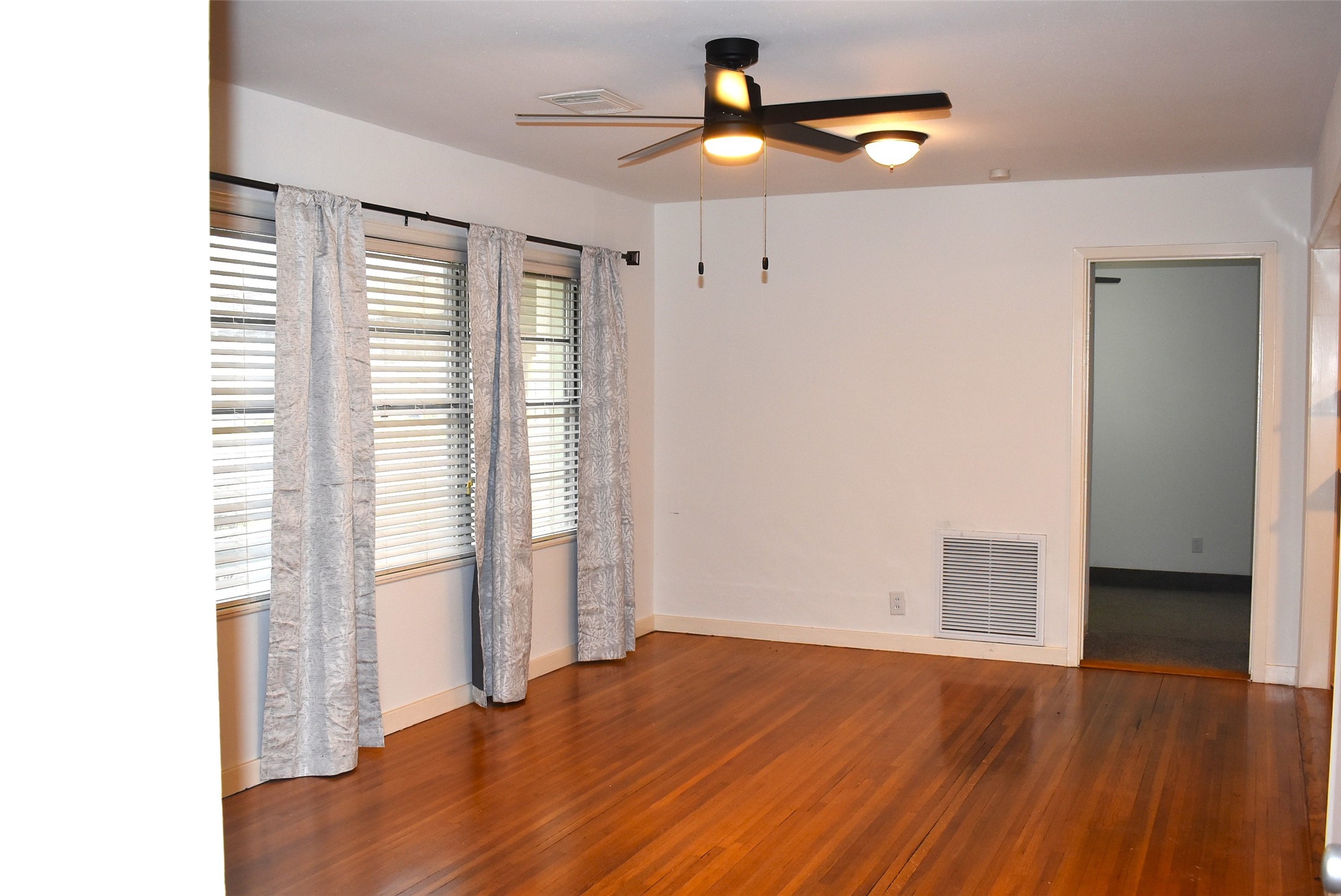 1006 Mac Drive Sweeny, TX 77480 - Photo 37 of 43 a view of an empty room with wooden floor and a window
