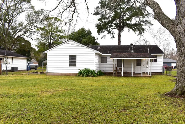 a front view of house with yard and trees