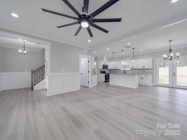a view of a kitchen with a dishwasher cabinets and wooden floor