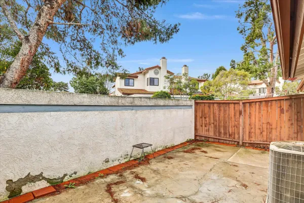 view of a house with a backyard and a tree