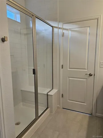 a bathroom with a glass shower door