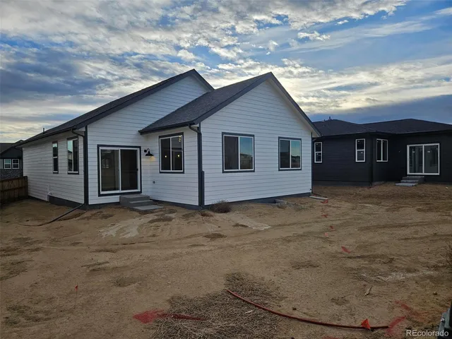a view of a house with a backyard