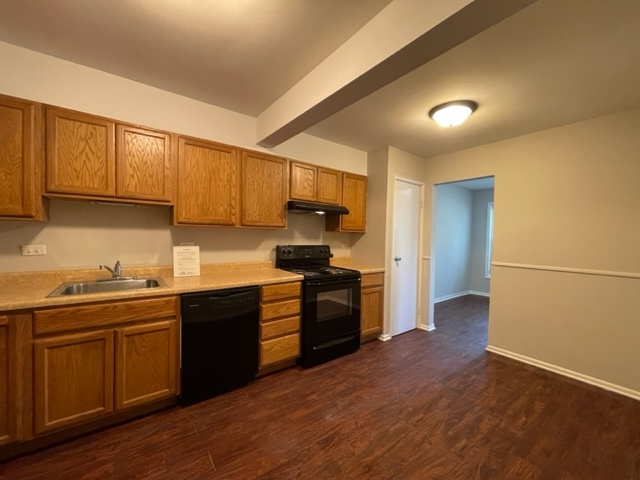 529 Jordan Way Bolingbrook, IL 60440 - Photo 11 of 23 a kitchen with granite countertop wooden floors and stainless steel appliances