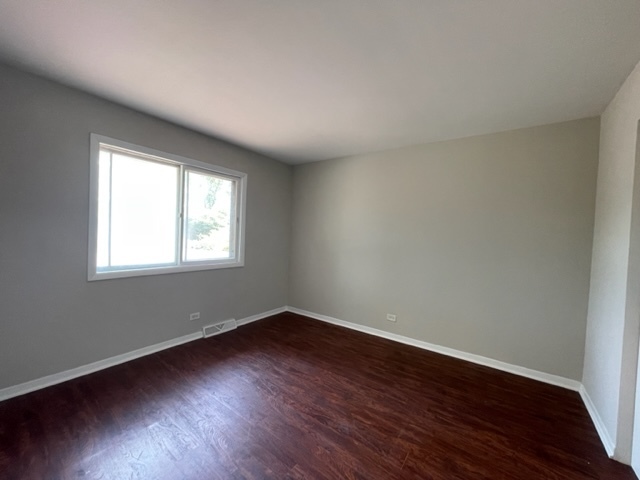 529 Jordan Way Bolingbrook, IL 60440 - Photo 18 of 23 a view of a room with wooden floor and windows in it