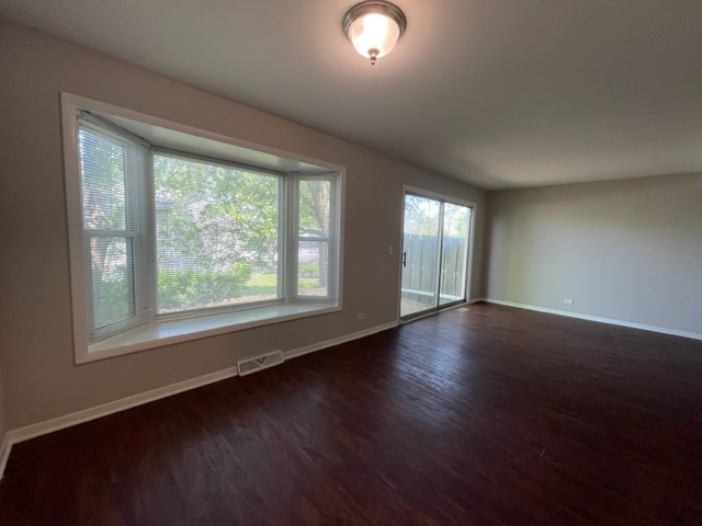 529 Jordan Way Bolingbrook, IL 60440 - Photo 9 of 23 an empty room with wooden floor and windows