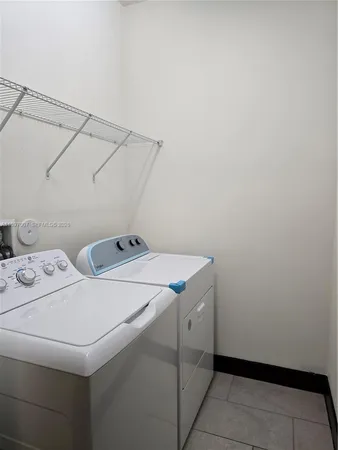 a bathroom with a double vanity sink toilet and shower
