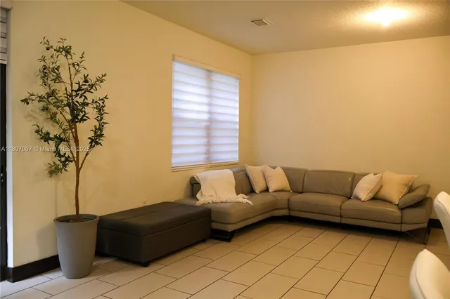 a kitchen with stainless steel appliances granite countertop a sink a stove a refrigerator cabinets and chairs