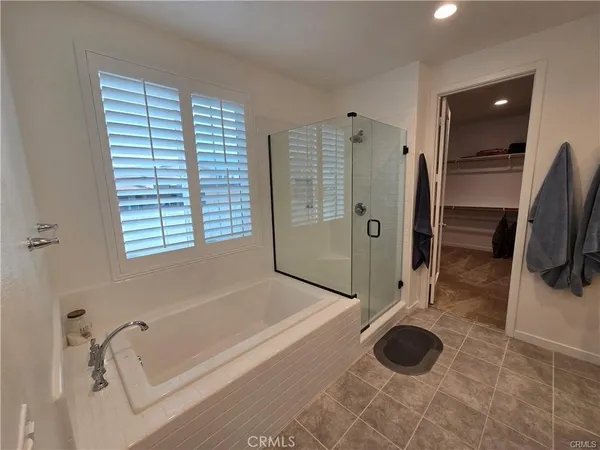 a bathroom with a tub a toilet and a shower