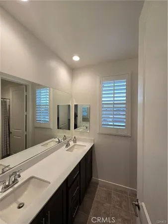 a spacious bathroom with a sink double vanity and a mirror
