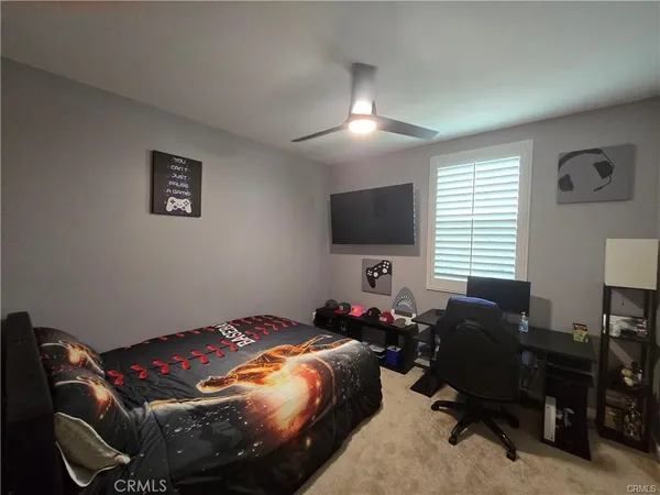 a bedroom with bed and a flat screen tv