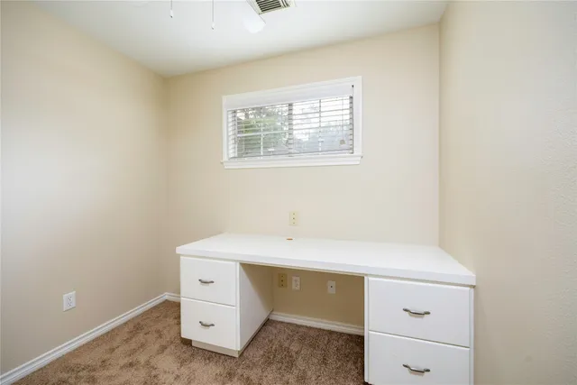 a room with a sink cabinets and a window