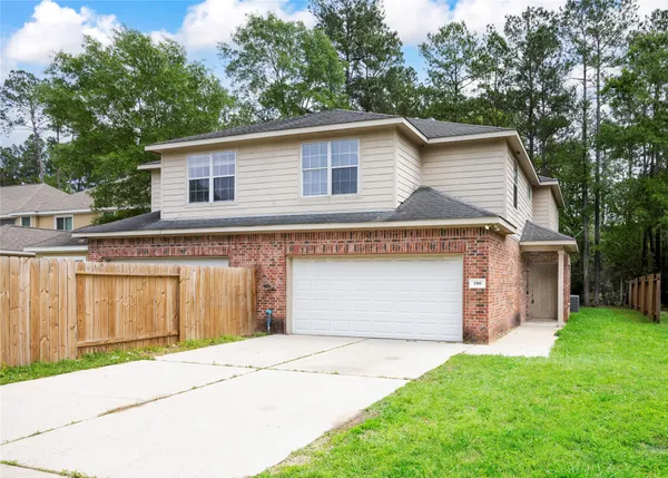 a front view of a house with a garden and garage