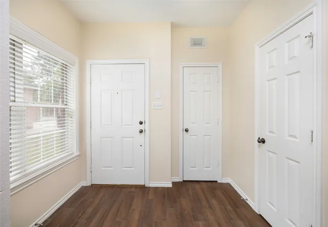 a view of a room with wooden floor and window