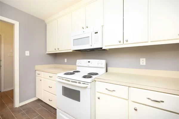 a kitchen with cabinets appliances and a sink