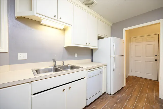 a kitchen with a sink and refrigerator