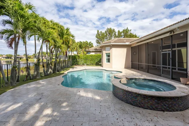 an aerial view of residential houses with outdoor space and swimming pool