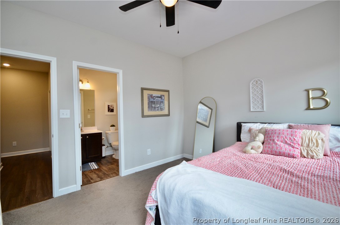 1865 John B Carter Road Fayetteville, NC 28312 - Photo 24 of 49 a bedroom with a bed and a chandelier