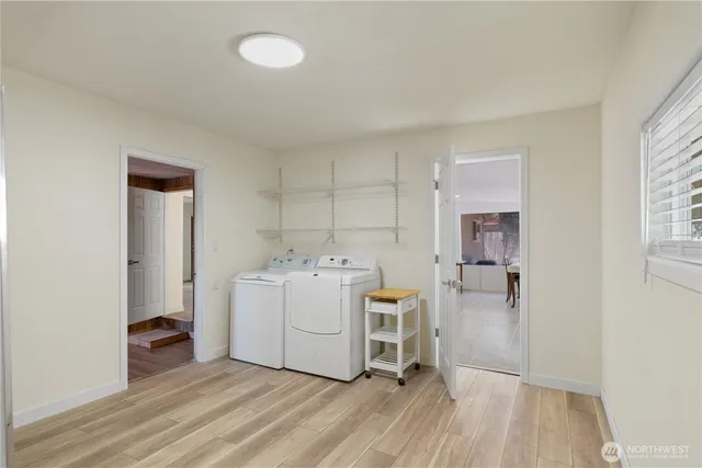 a utility room with cabinets washer and dryer