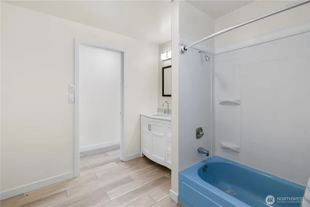 a bathroom with a sink a mirror and a bathtub