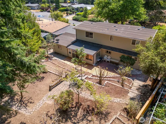 an aerial view of a house with backyard and outdoor seating