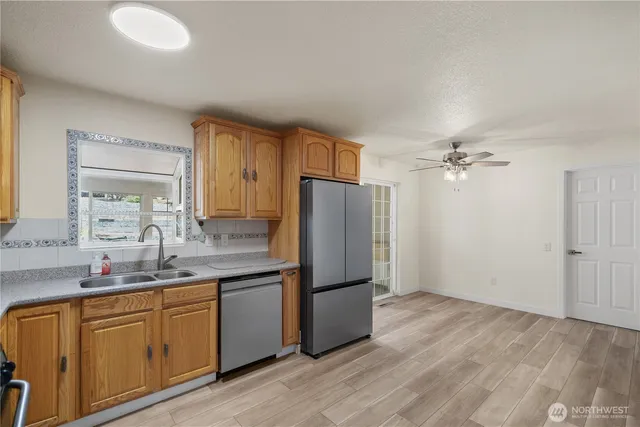 a kitchen with stainless steel appliances granite countertop a refrigerator and a sink