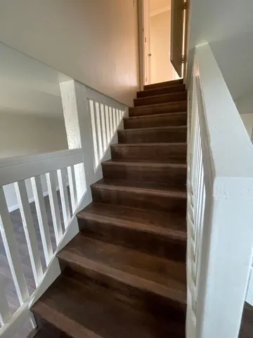 a view of hallway with livingroom and wooden floor
