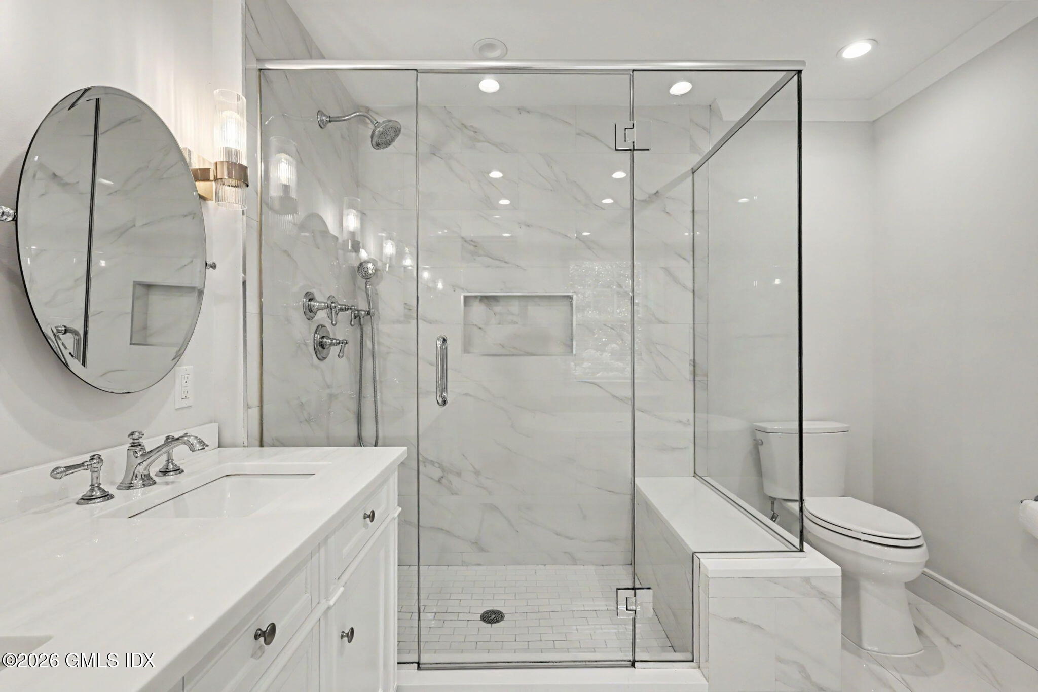 124 Shore Road Old Greenwich, CT 06870 - Photo 19 of 28 a bathroom with a sink a toilet and a mirror