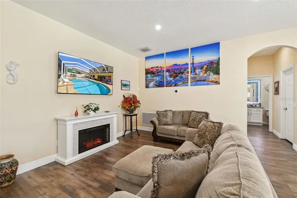 a kitchen with stainless steel appliances kitchen island granite countertop a table chairs and a refrigerator