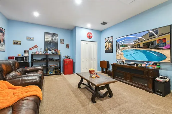 a kitchen with stainless steel appliances granite countertop a sink a stove a refrigerator a dining table and chairs
