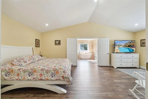 a living room with furniture a rug and a floor to ceiling window