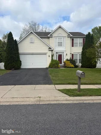 a view of a yard in front view of a house
