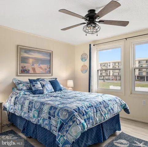 a bedroom with a bed a television and dresser