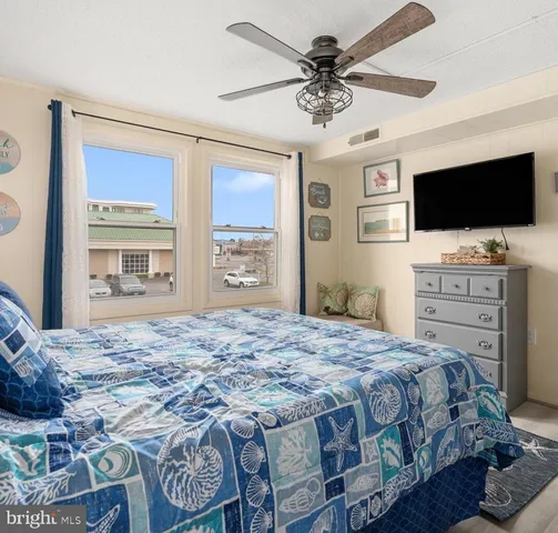 a bedroom with a large bed and a chandelier