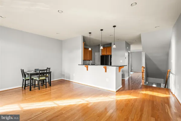 a view of a kitchen with furniture and wooden floor