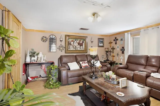 a living room with furniture and wooden floor