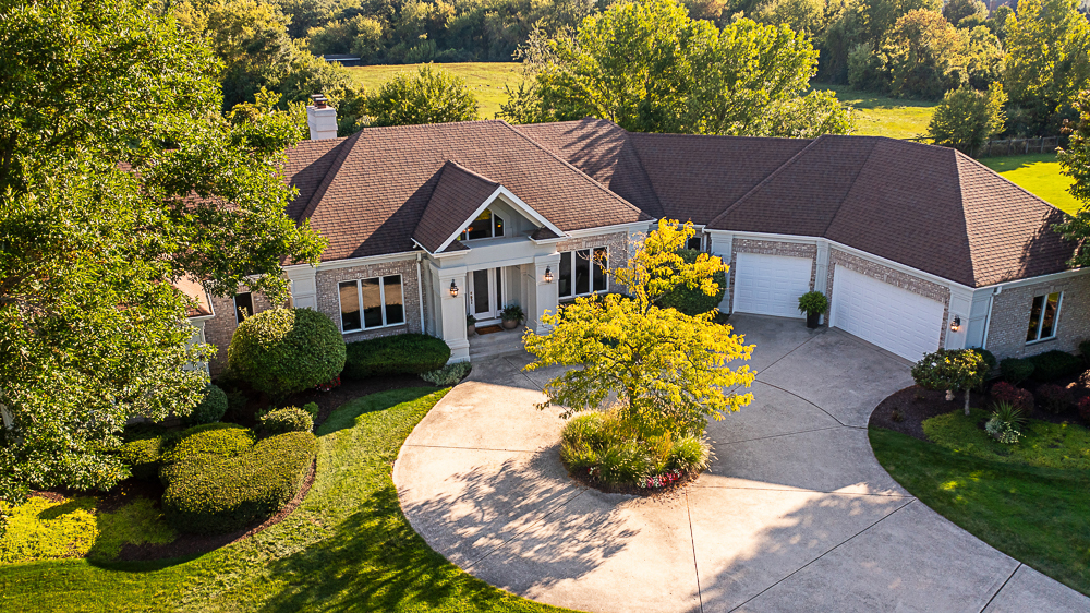 a view of a house with a yard and potted plants