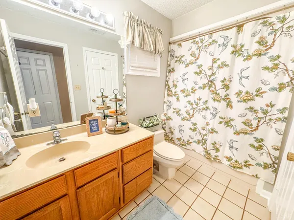 a bedroom with a bed and a shower curtain
